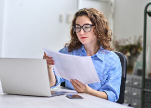 young woman holding small business insurance audit report
